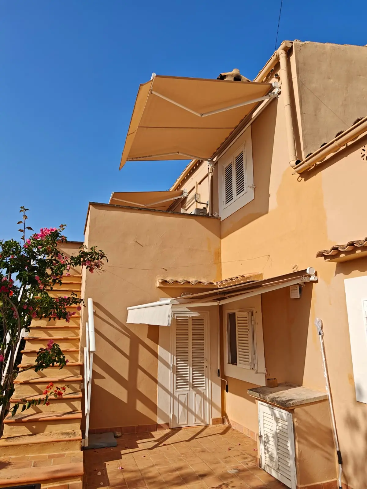 Zwei Gelenkarmmarkisen an einem mallorquinischen Haus